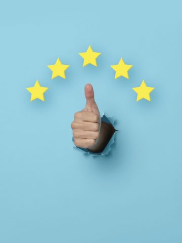 Customer Experience Woman hand thumb up vote on five star excellent rating on blue background. Review and feedback concept.